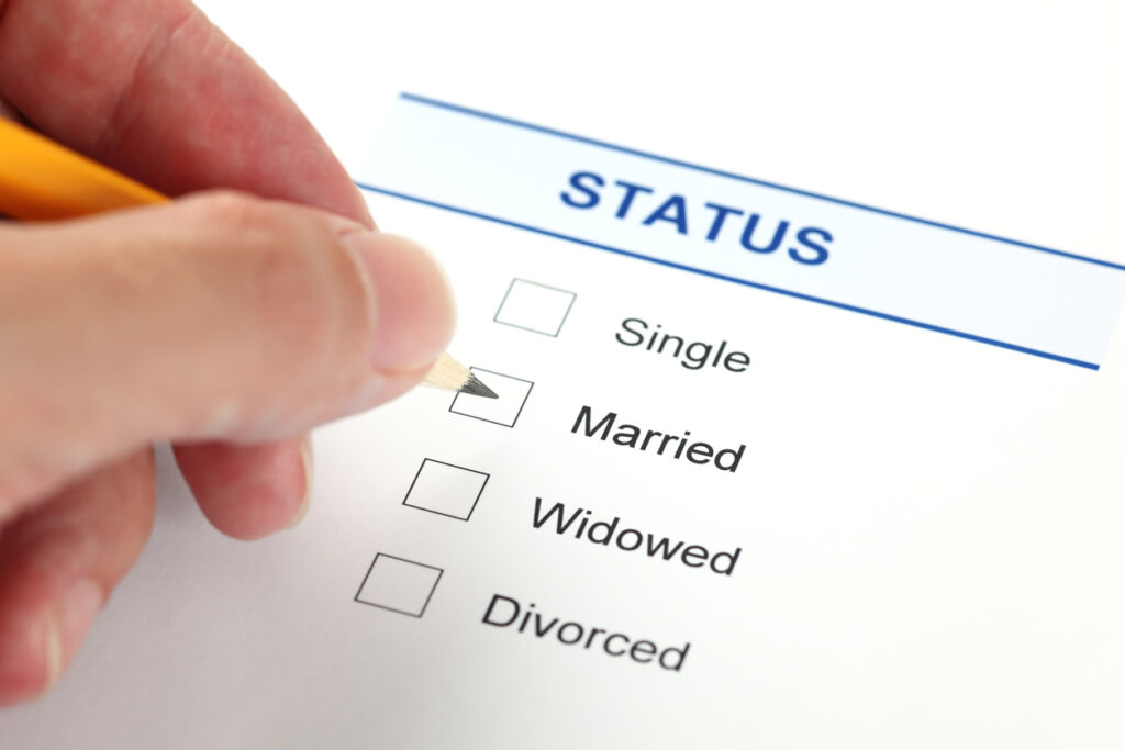 Hand selecting married status on a form